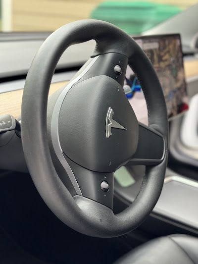 A close up of a tesla model 3 steering wheel
