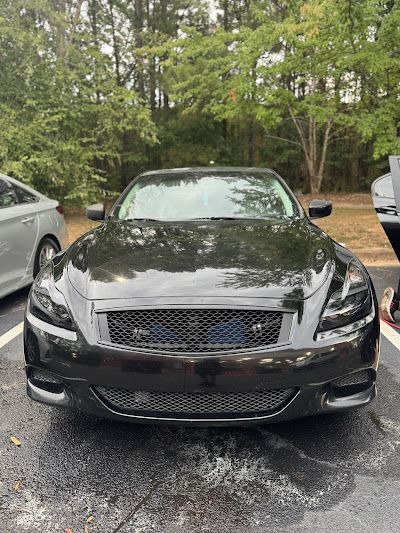 A black sports car is parked in a parking lot.