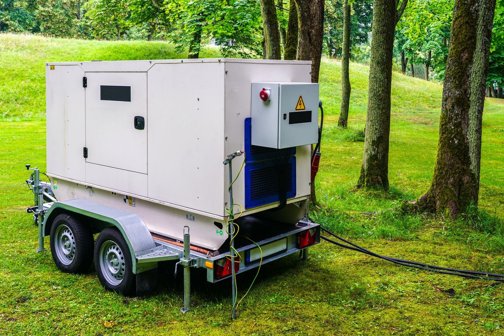Connected large rental diesel generator on a mobile trailer for outdoor event power supply.