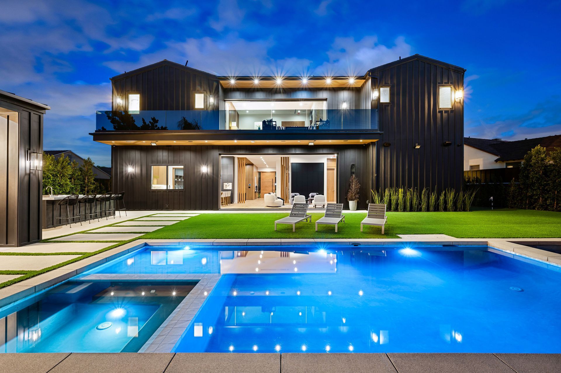 A large house with a large swimming pool in front of it.