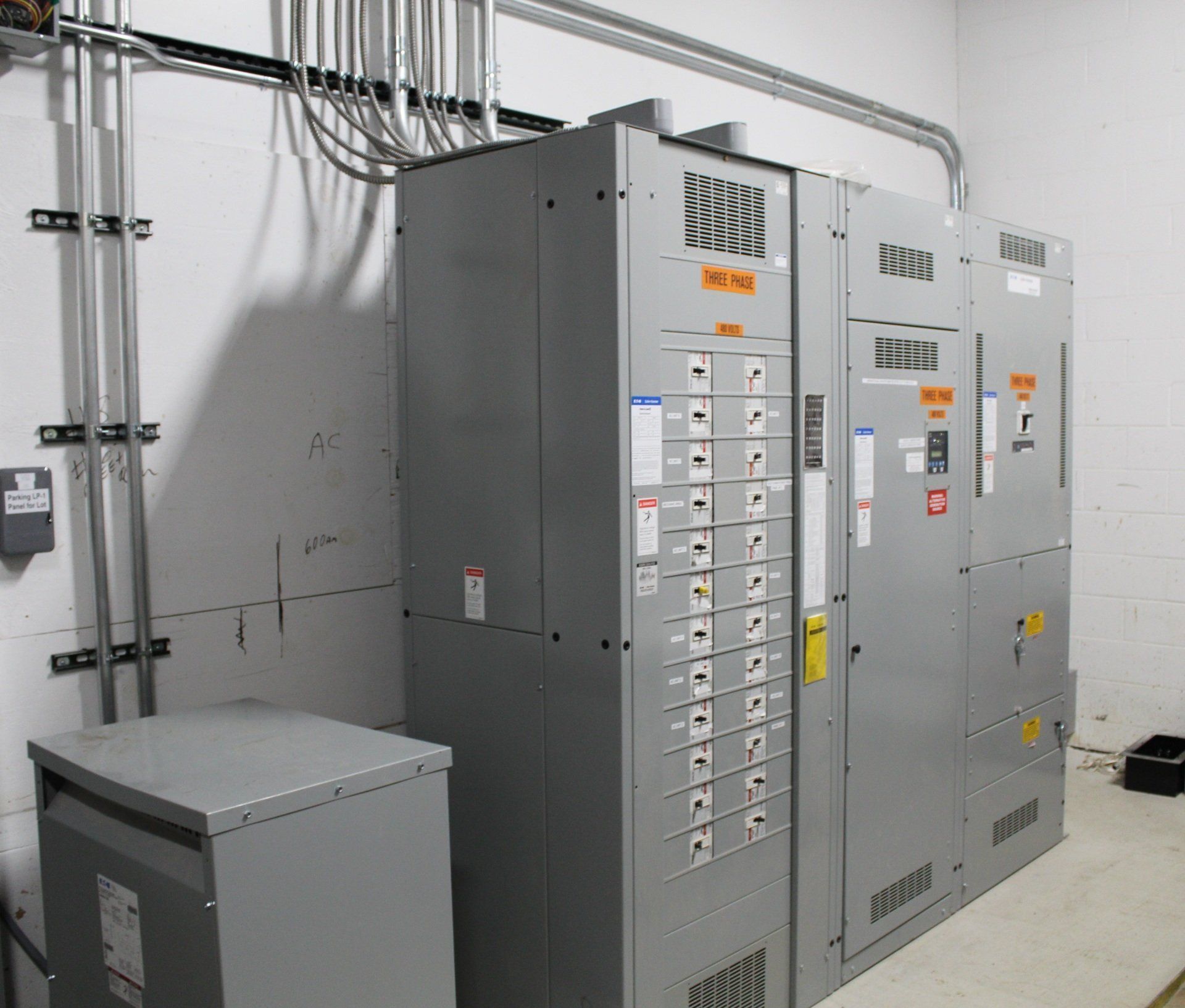 A room with a lot of electrical boxes and a transformer