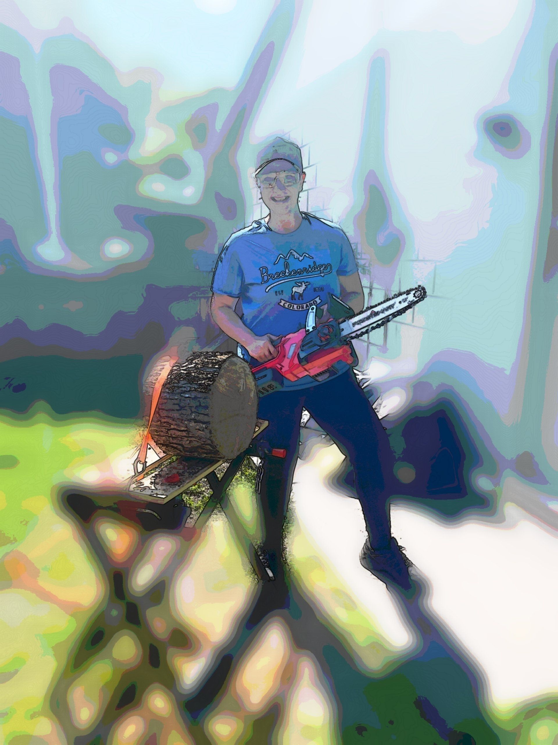 A man in a blue shirt is cutting a log with a chainsaw.