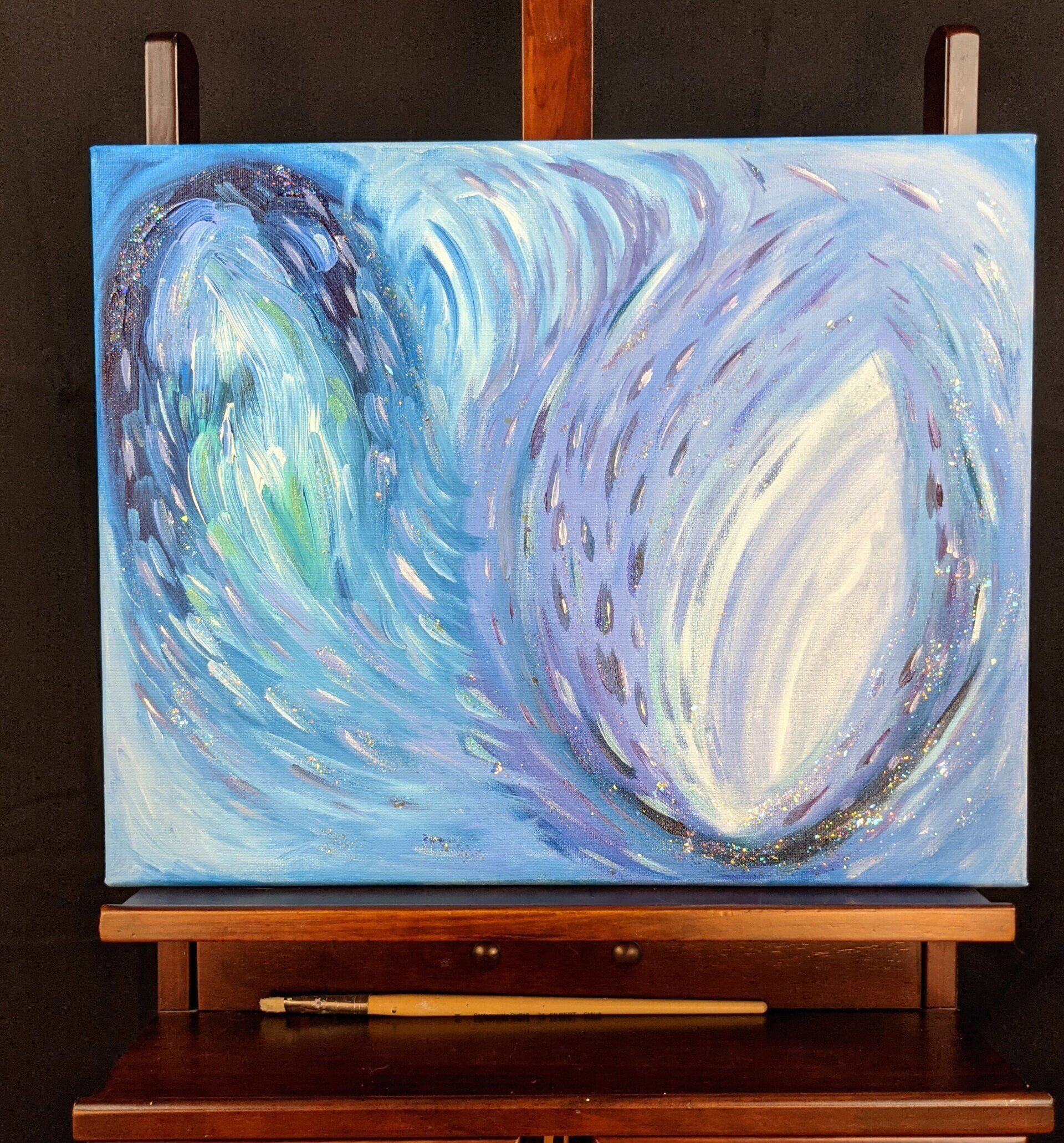 A painting of two hearts on a wooden easel