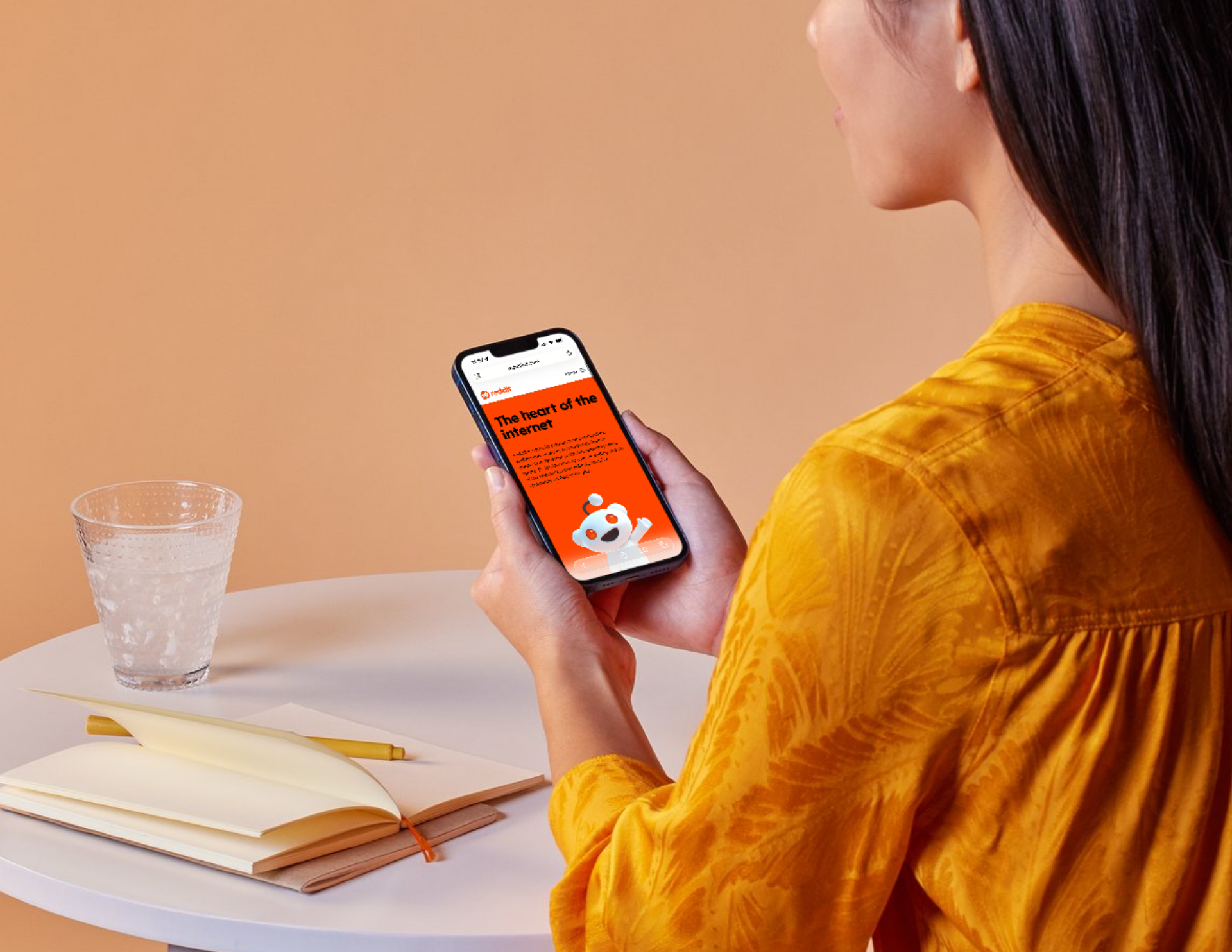 Woman on cellphone looking at Reddit page