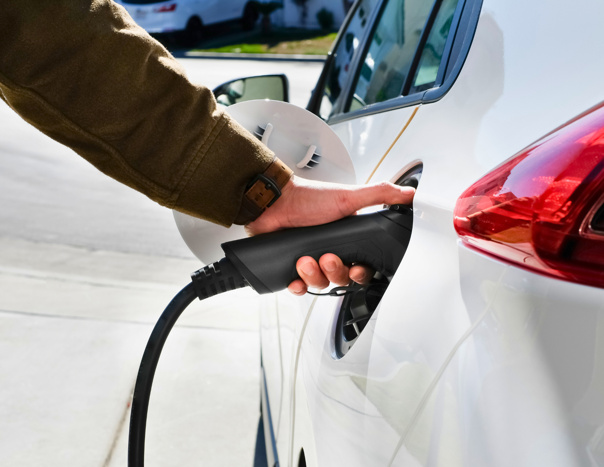 Person plugging in electric vehicle