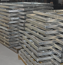 A stack of metal frames sitting on top of wooden pallets