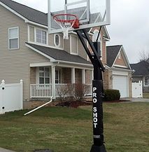 A basketball hoop is sitting in front of a house.