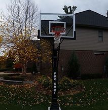 A basketball hoop is sitting in front of a house.