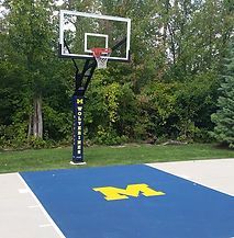 A basketball hoop is sitting on top of a blue basketball court.
