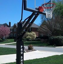 A basketball hoop is sitting in the middle of a residential neighborhood.