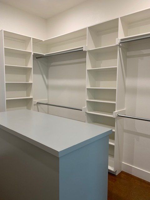 There is a large island in the middle of the closet.