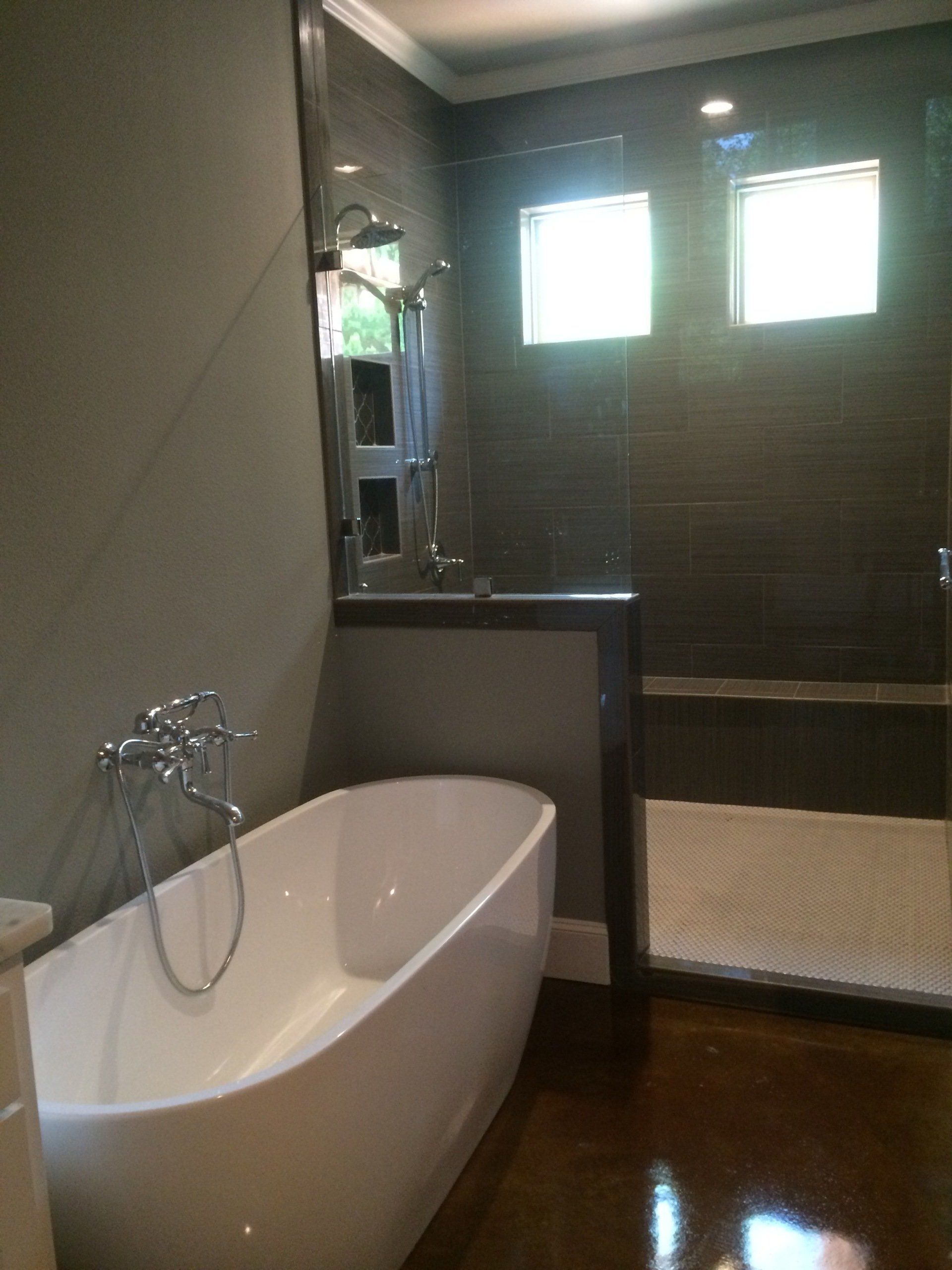 A bathroom with a bathtub and a walk in shower.