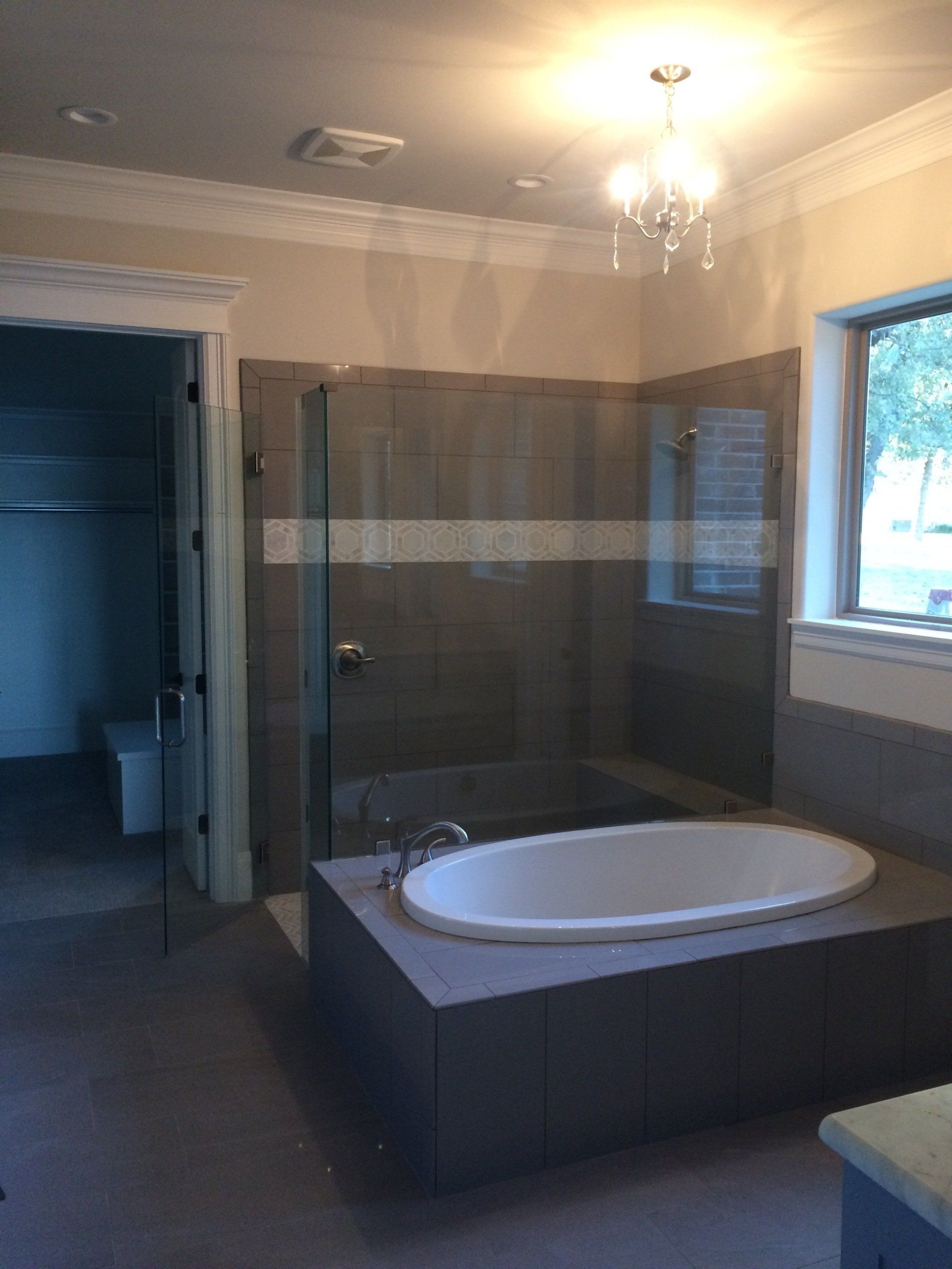 A bathroom with a bathtub and a shower stall