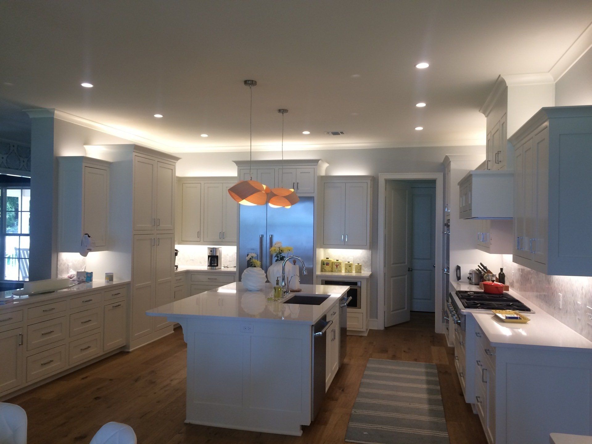 A kitchen with white cabinets and stainless steel appliances