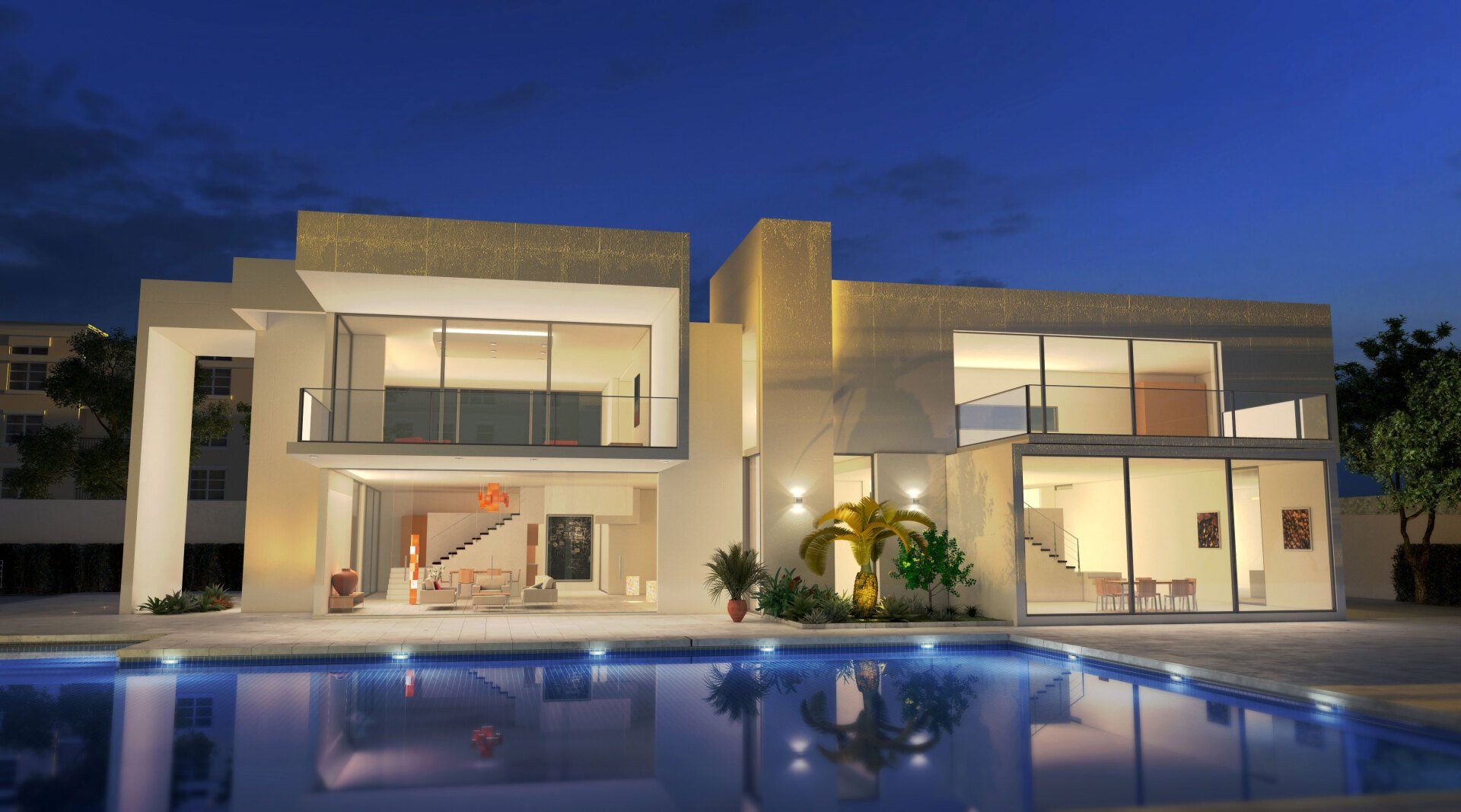 A large white house with a swimming pool in front of it at night.