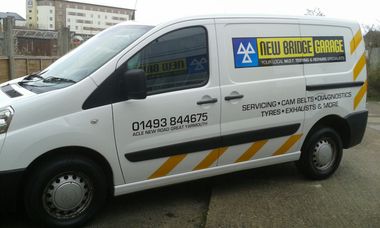 Van displaying sign from business