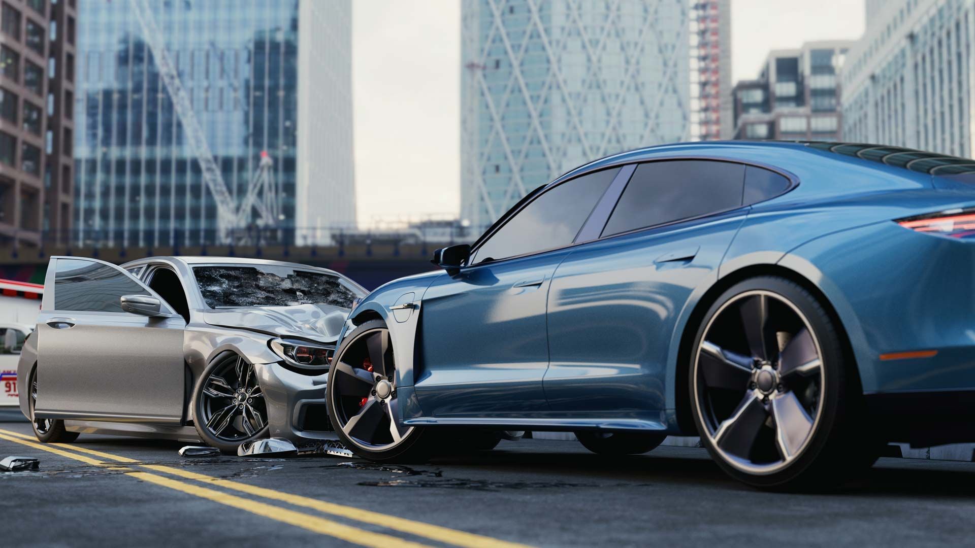 Two cars damaged in a collision on a city street; one blue, one silver.