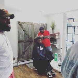 Man getting a haircut in a room