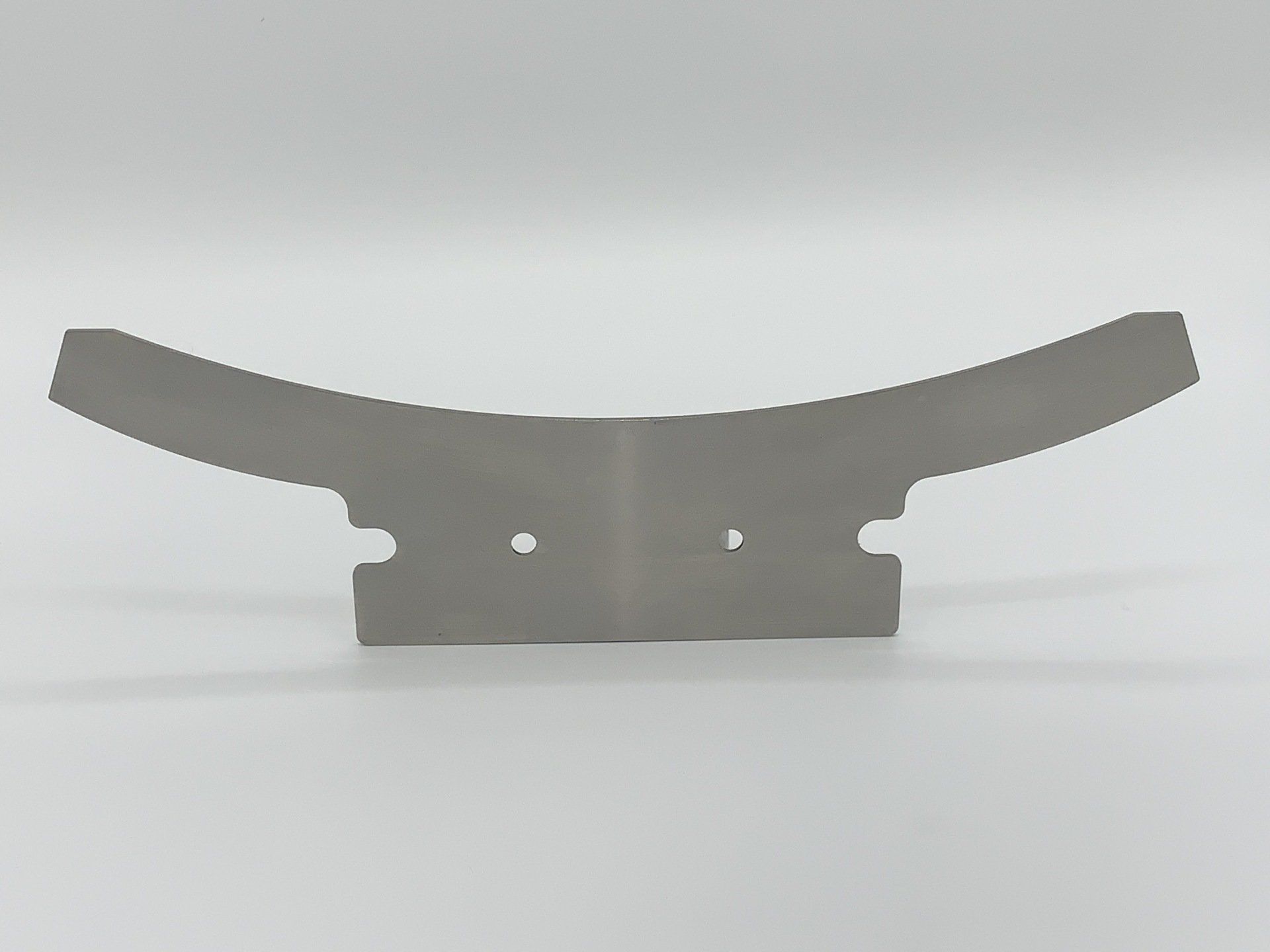 A piece of metal is sitting on a white surface.