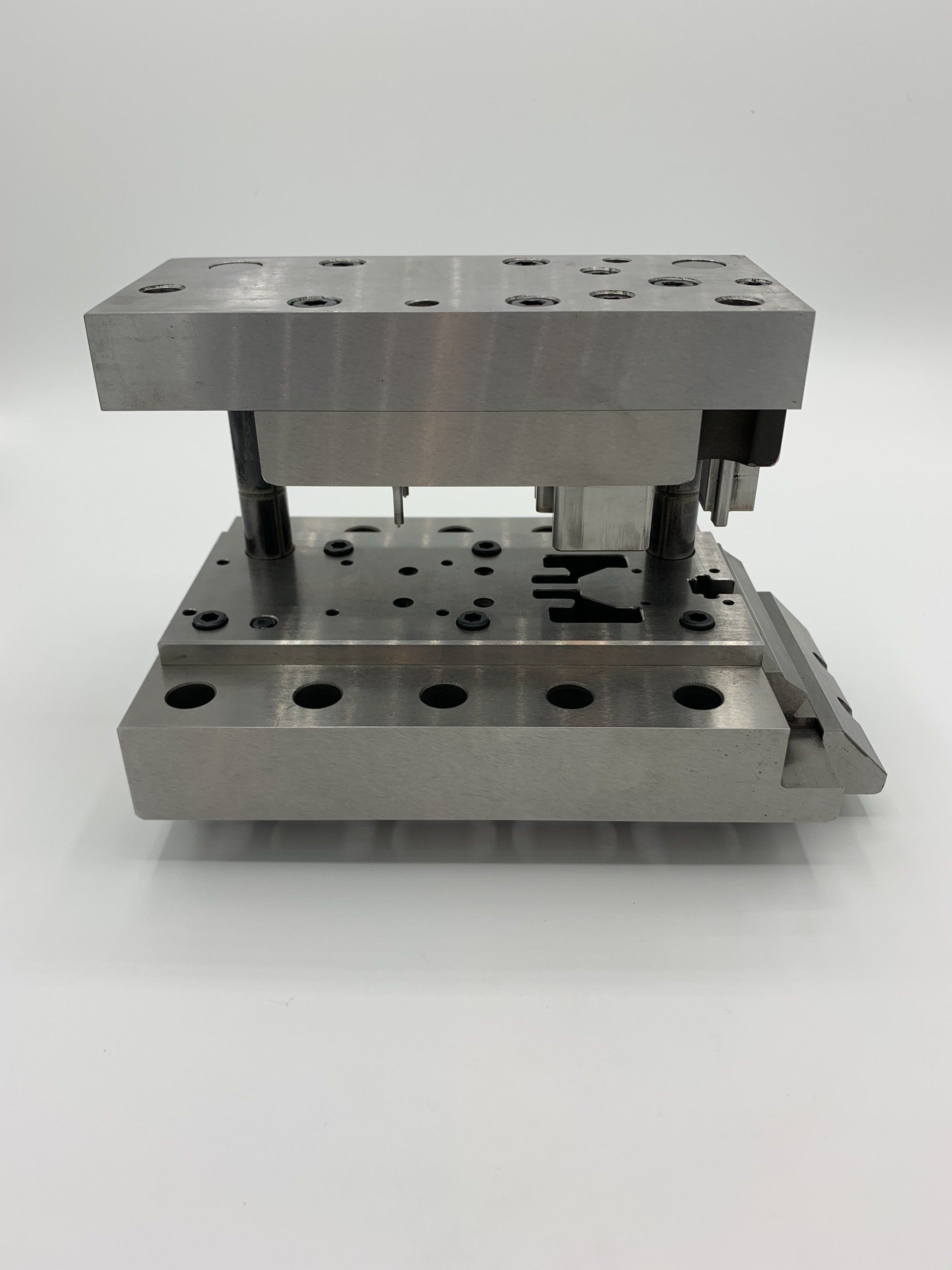 A metal tool is sitting on top of a white surface.