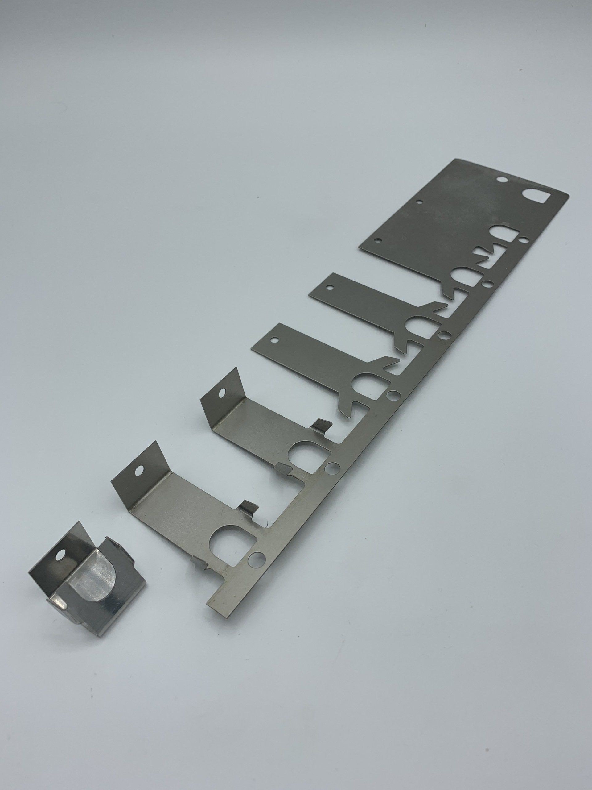 A piece of metal is sitting on a white surface.