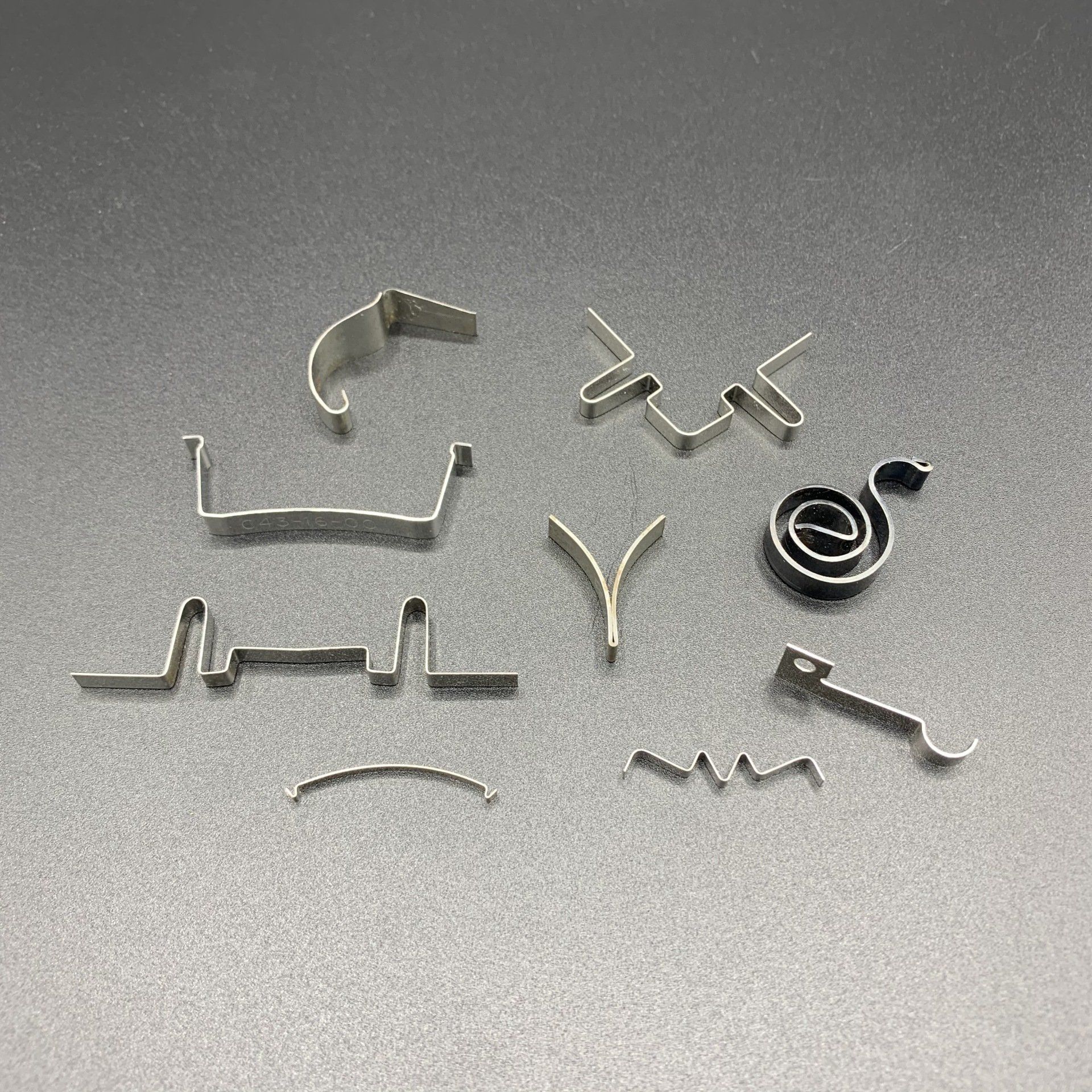 There are many different types of metal springs on the table.