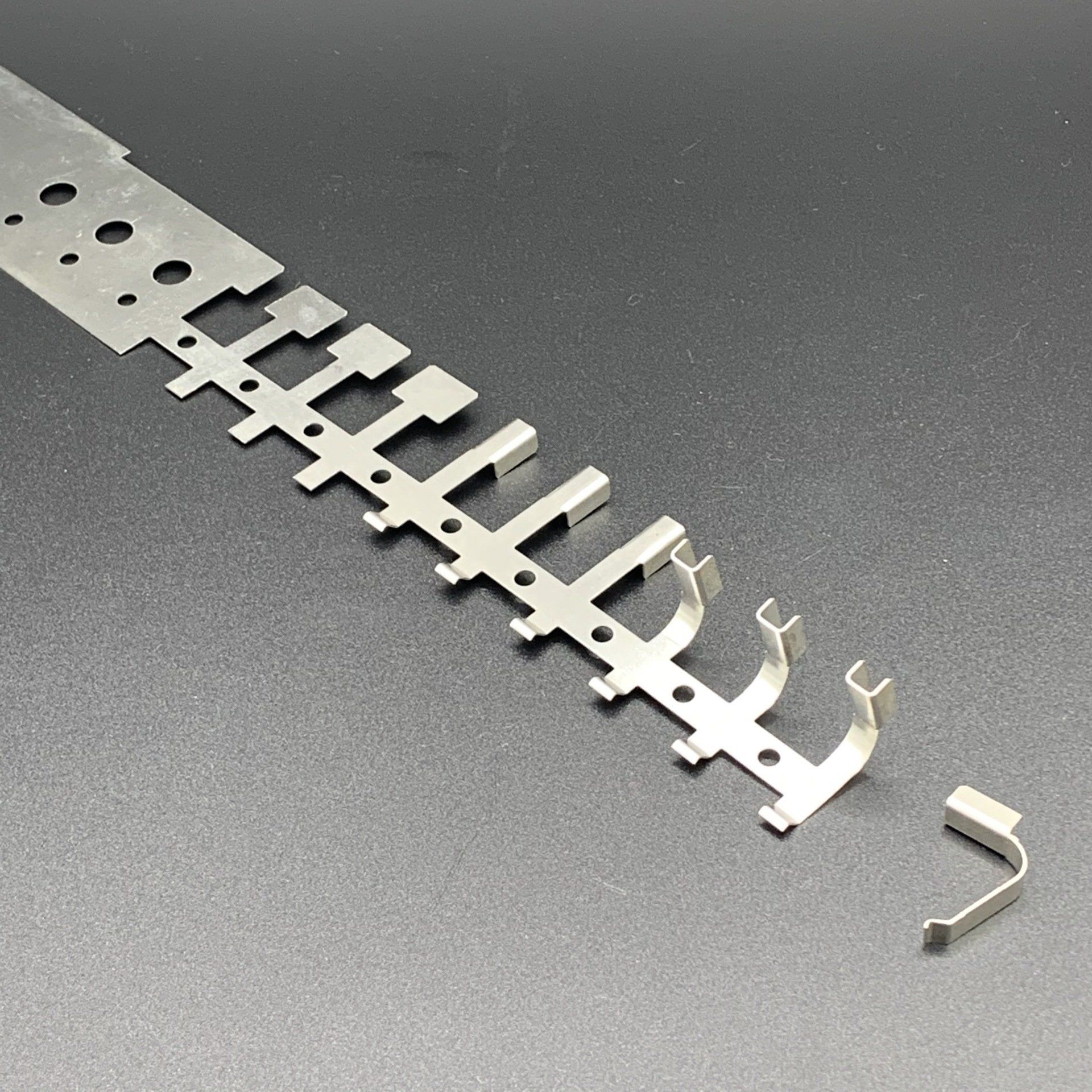 A row of metal pieces are sitting on a table.
