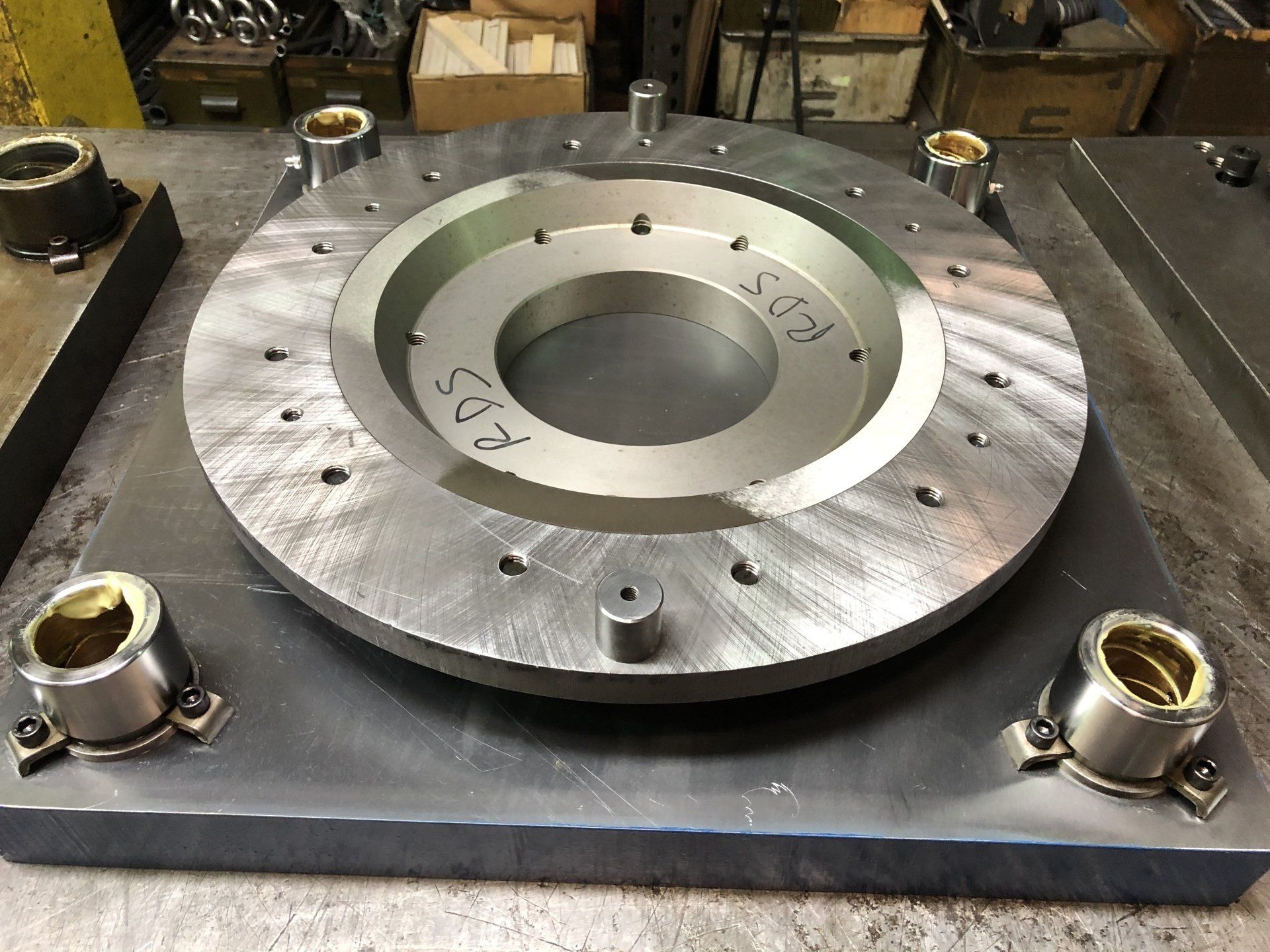 A metal plate with a hole in the middle is sitting on a table.