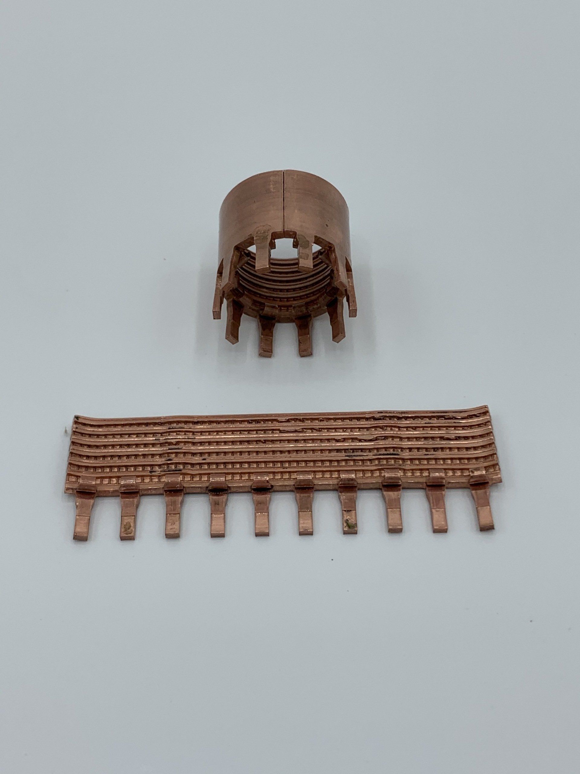 Two pieces of wood are sitting on a white surface.