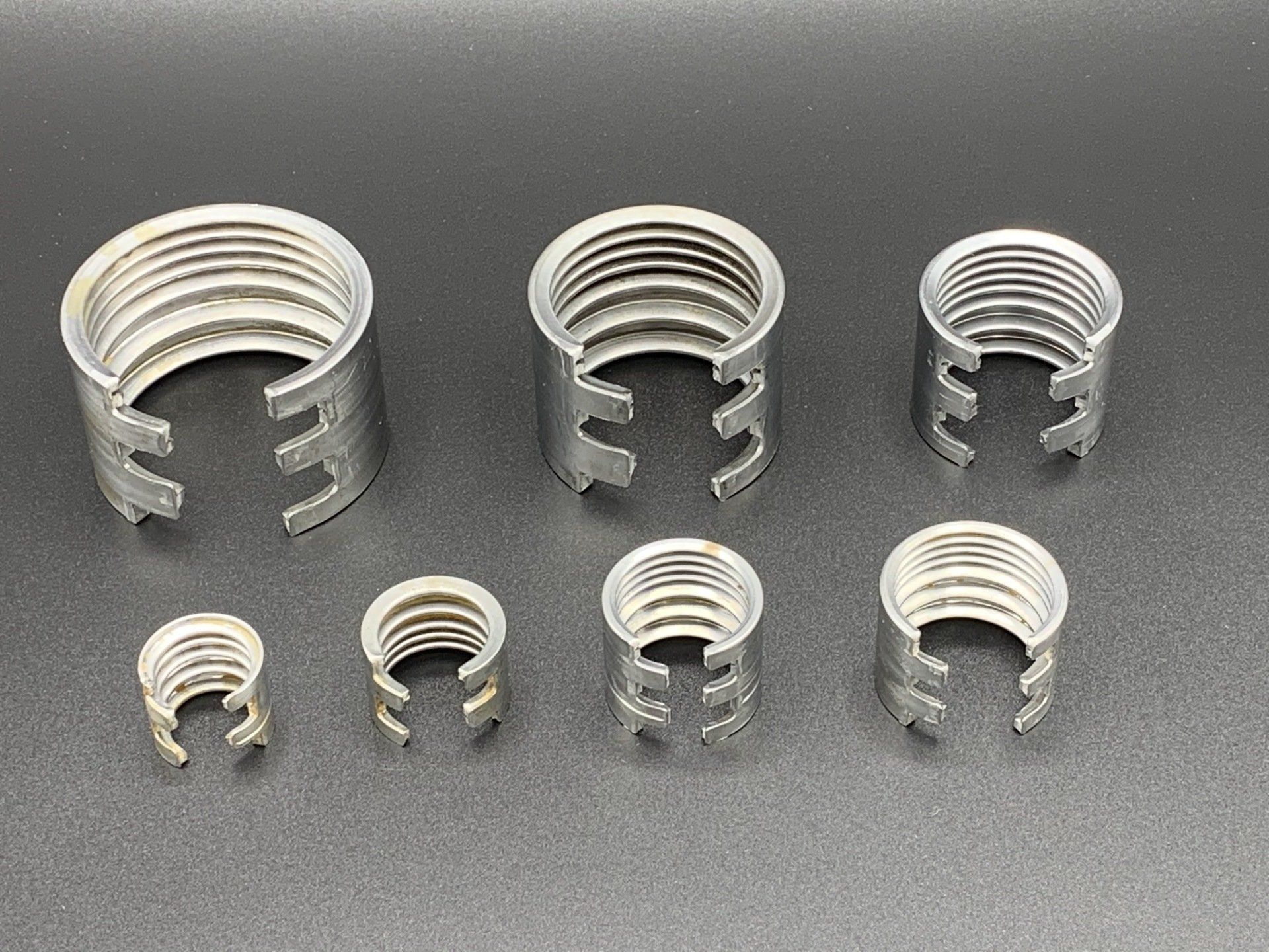 A group of metal rings of different sizes are sitting on a table.