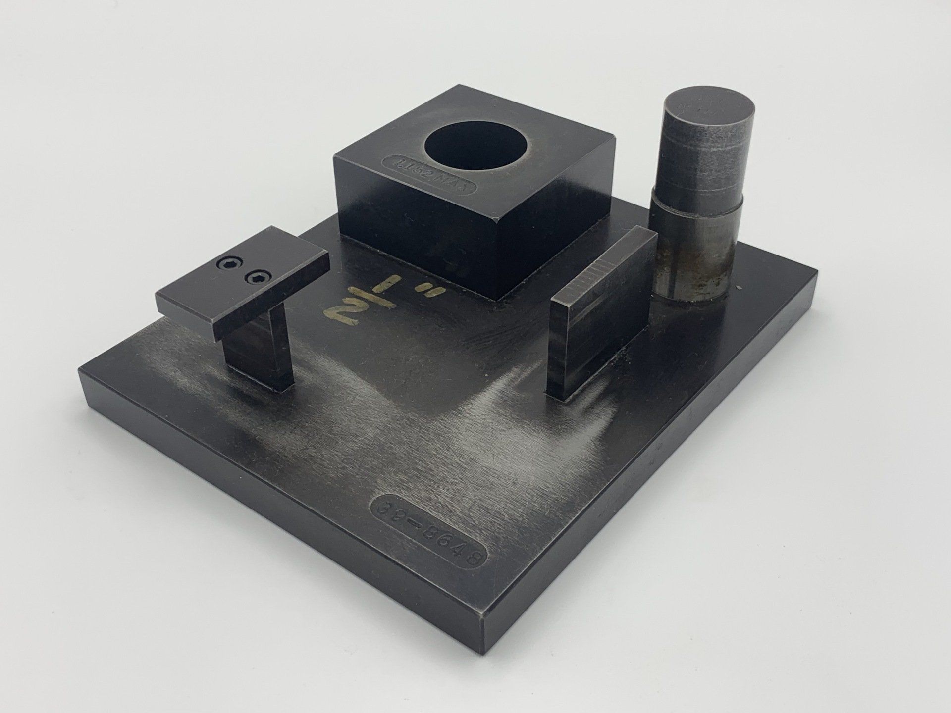 A black piece of metal with a hole in the middle