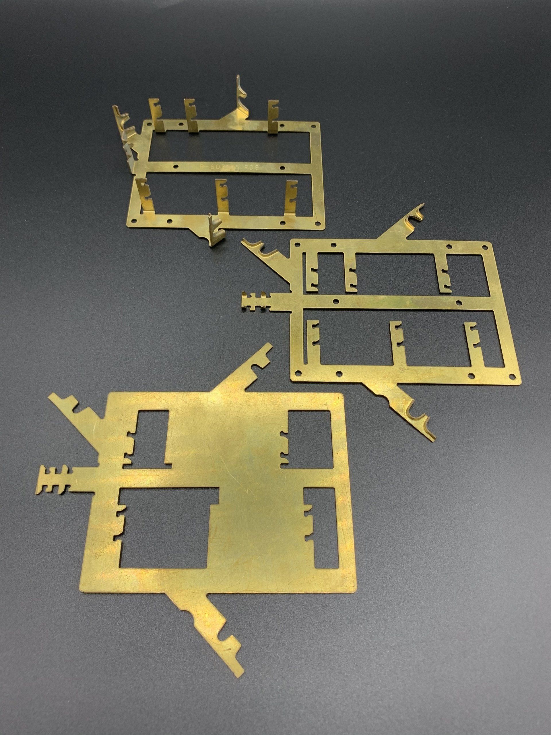 A bunch of brass pieces on a black surface