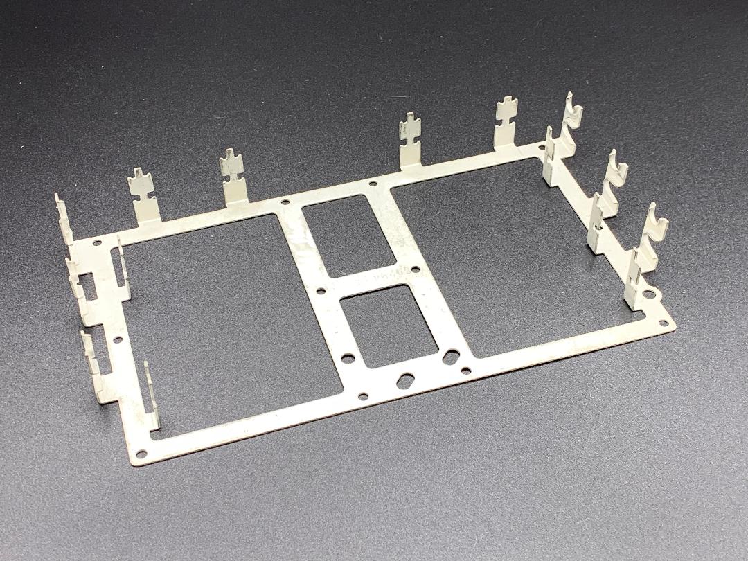 A metal frame with holes in it is sitting on a table.