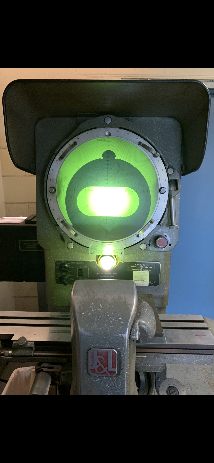 A close up of a machine with a green light on it.