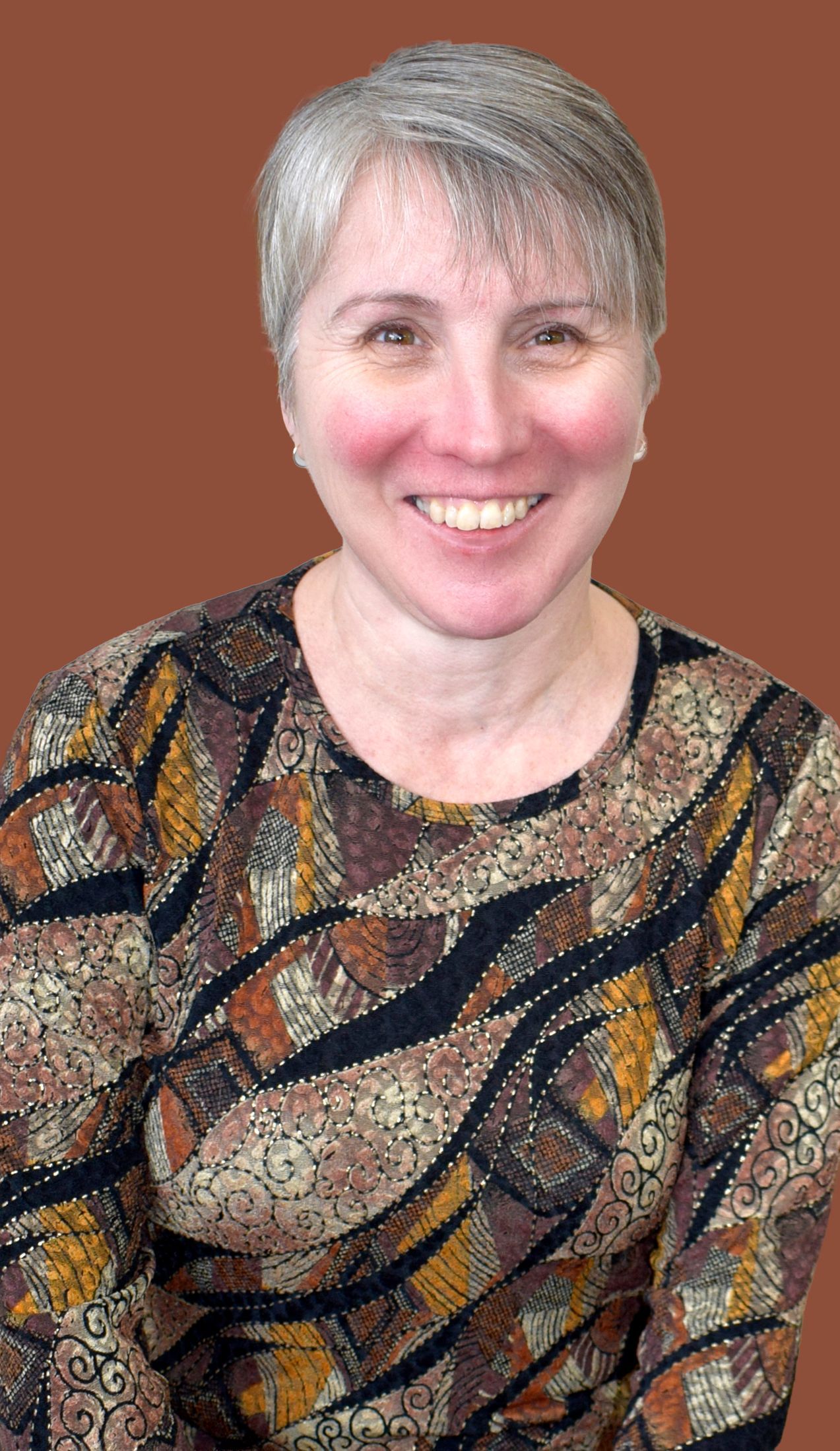 A woman is wearing a black jacket and a floral shirt