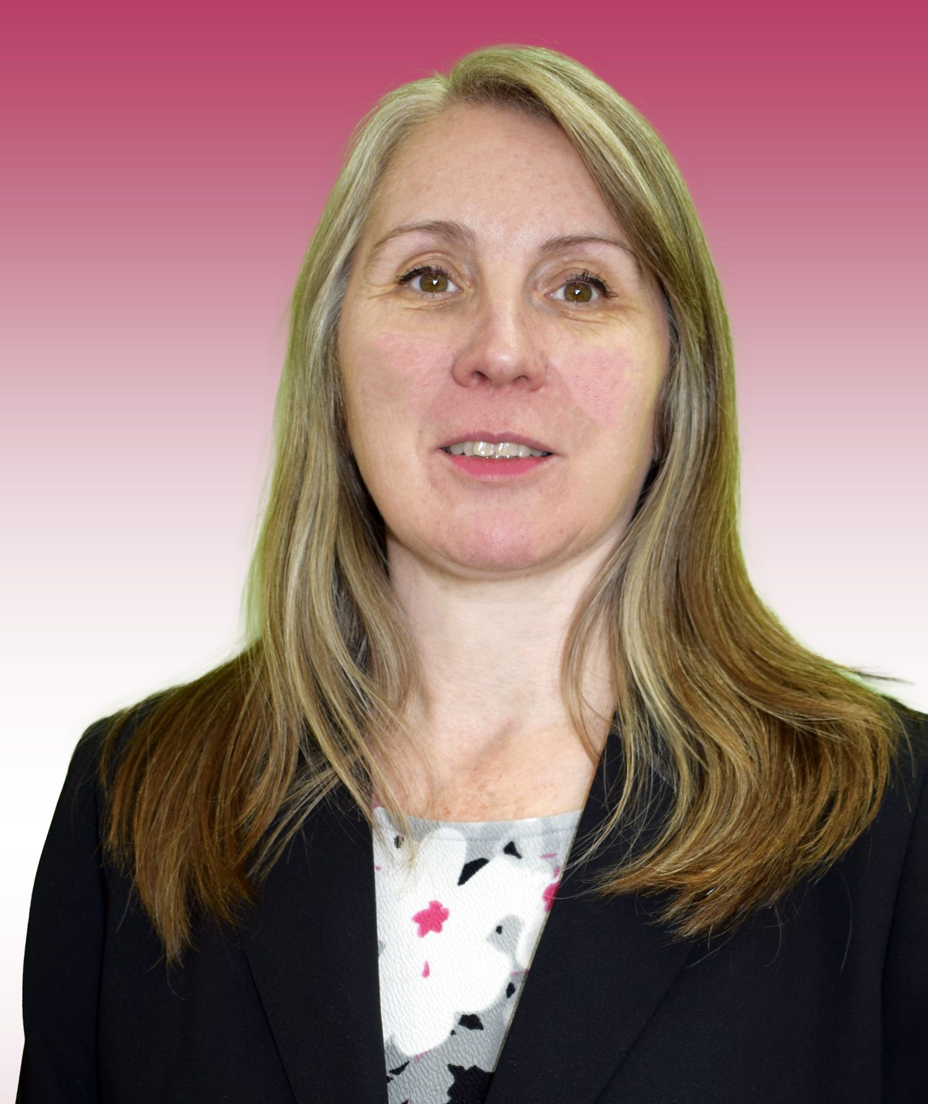 A woman is wearing a black jacket and a floral shirt