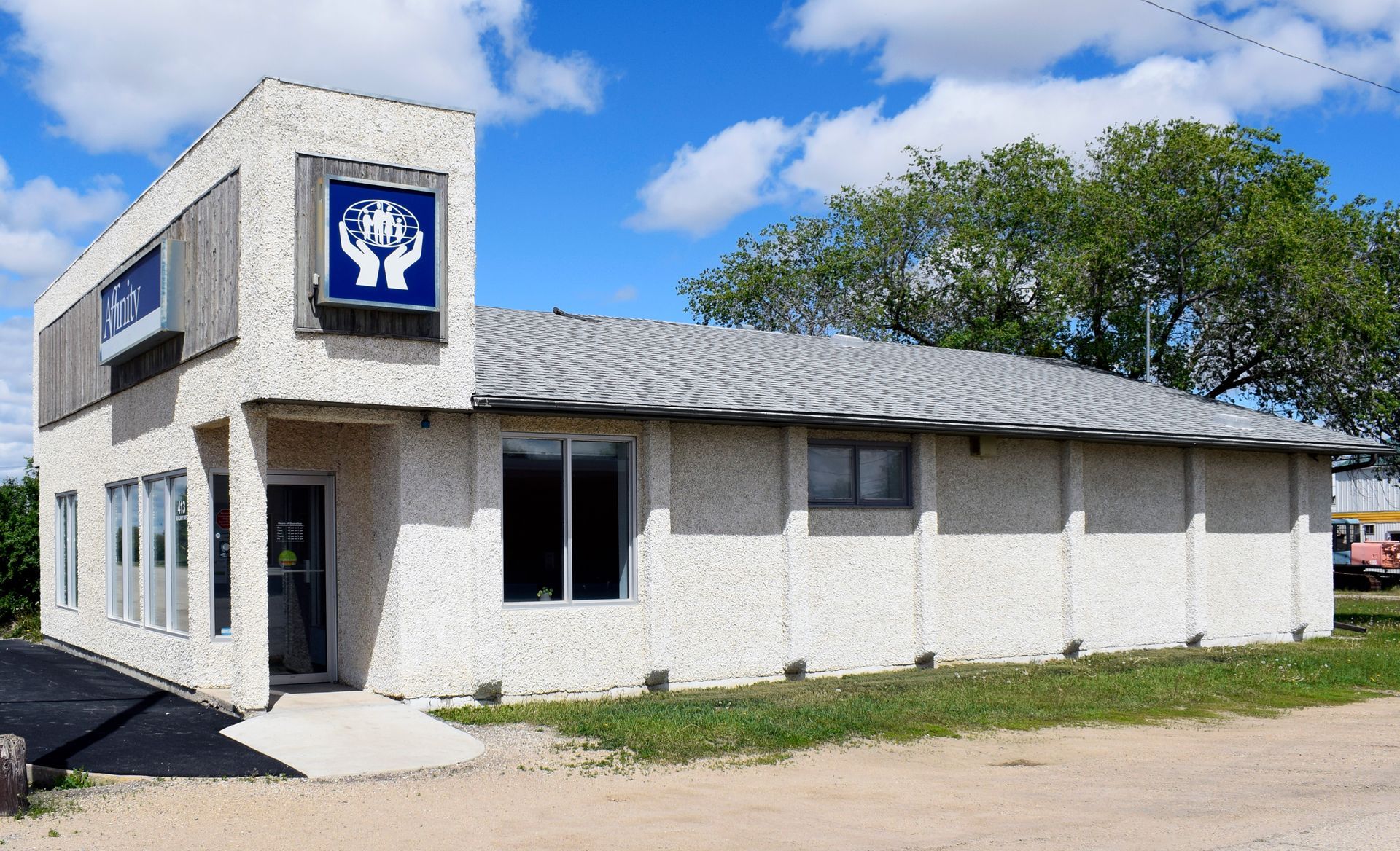 A white building with a blue sign that says ' y ' on it