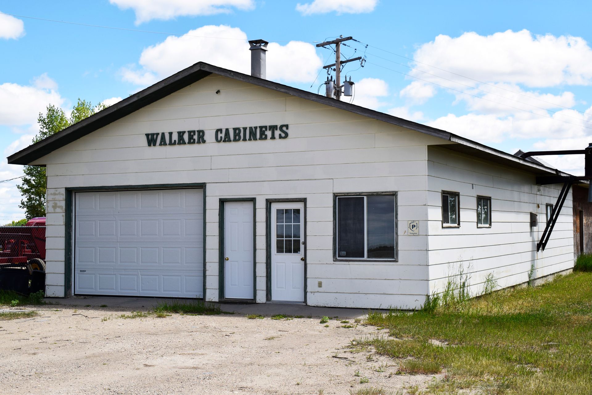 A white building with walker cabinets written on it