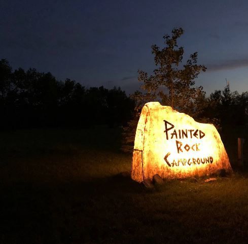 A large rock with painted rock written on it