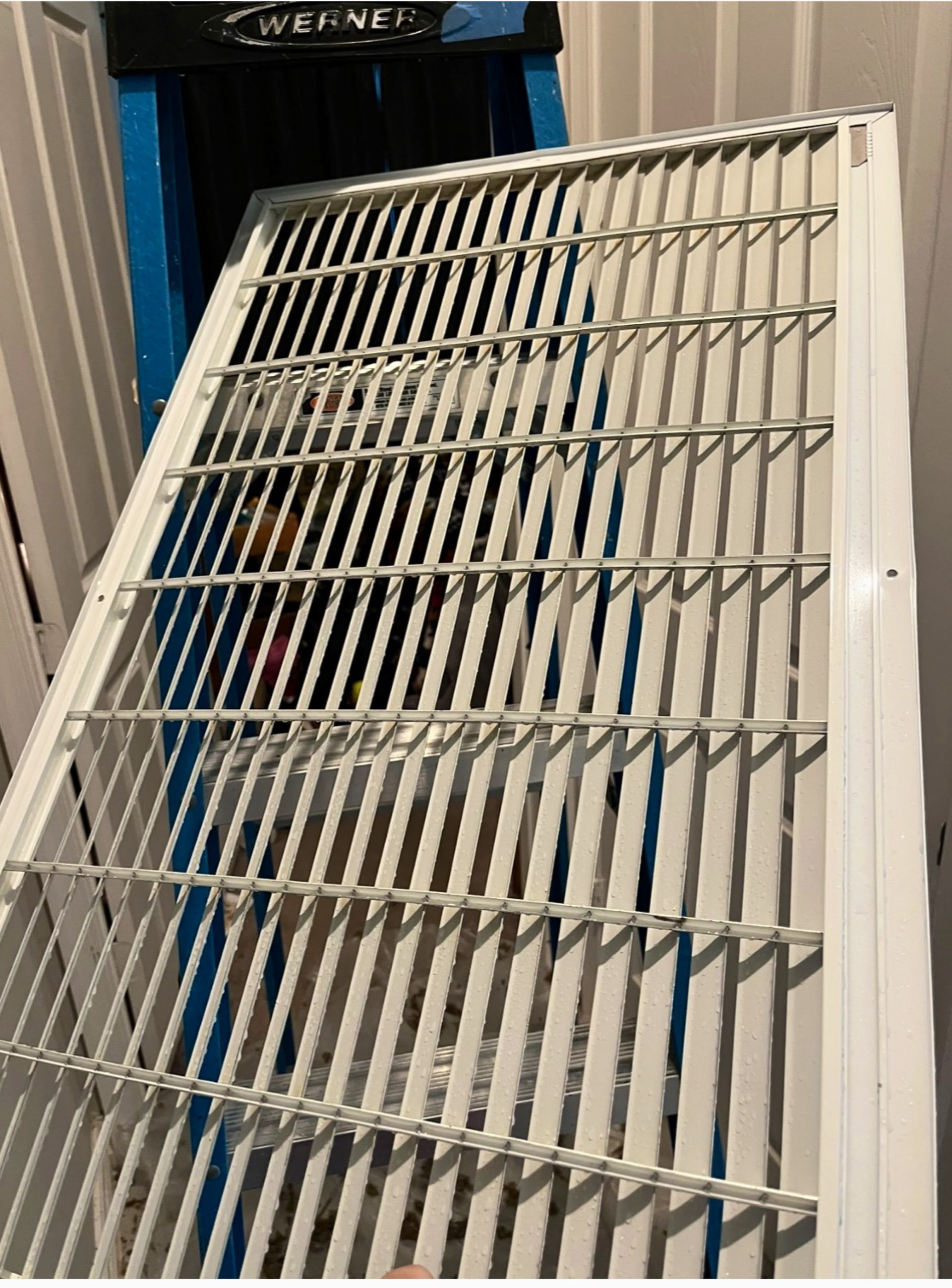 A close up of a metal grate on a wall