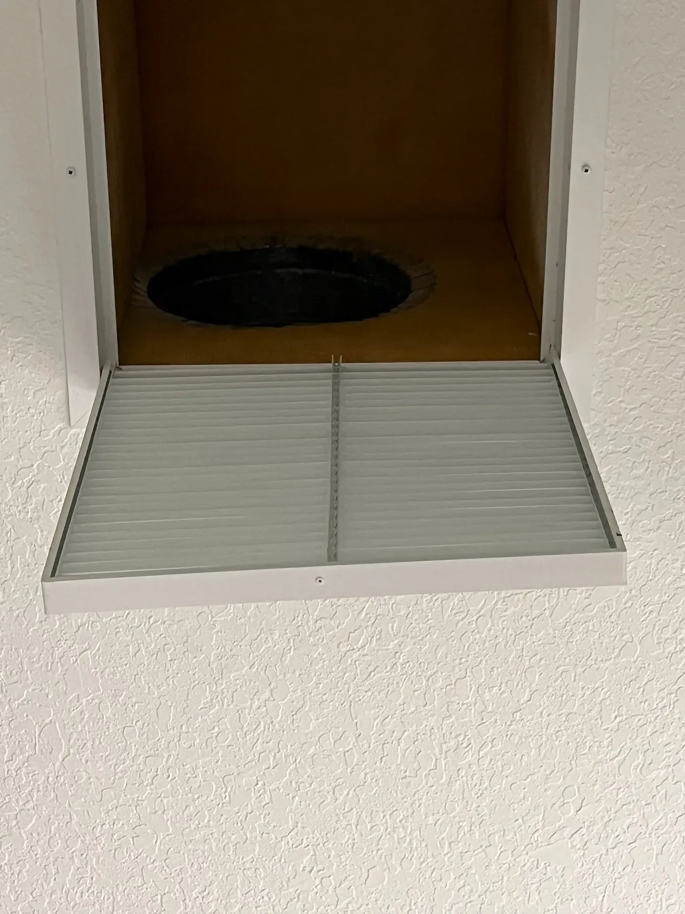 There is a hole in the wall that looks like a window.