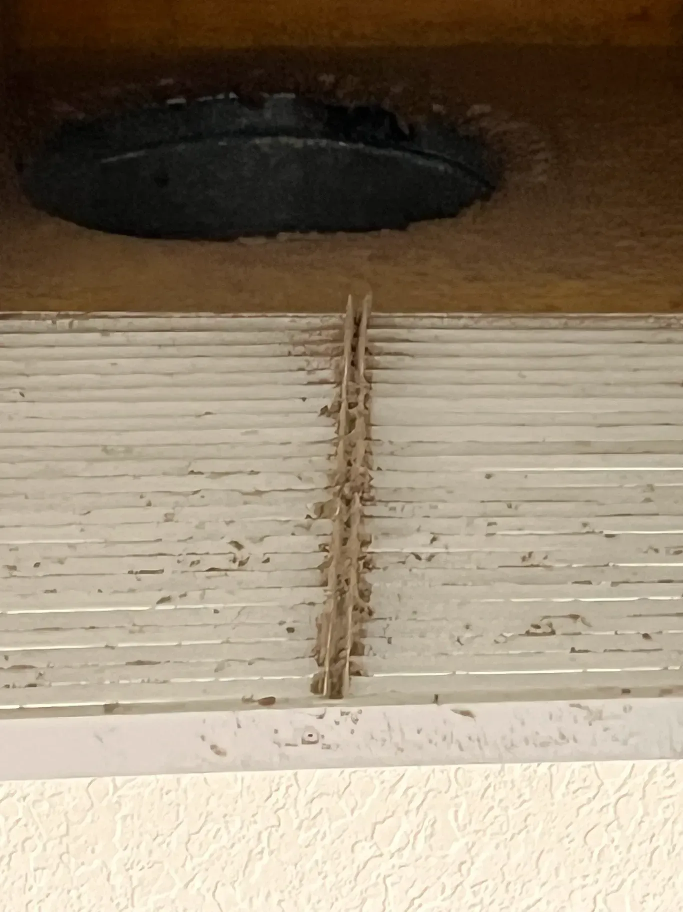 A close up of a vent with a hole in it