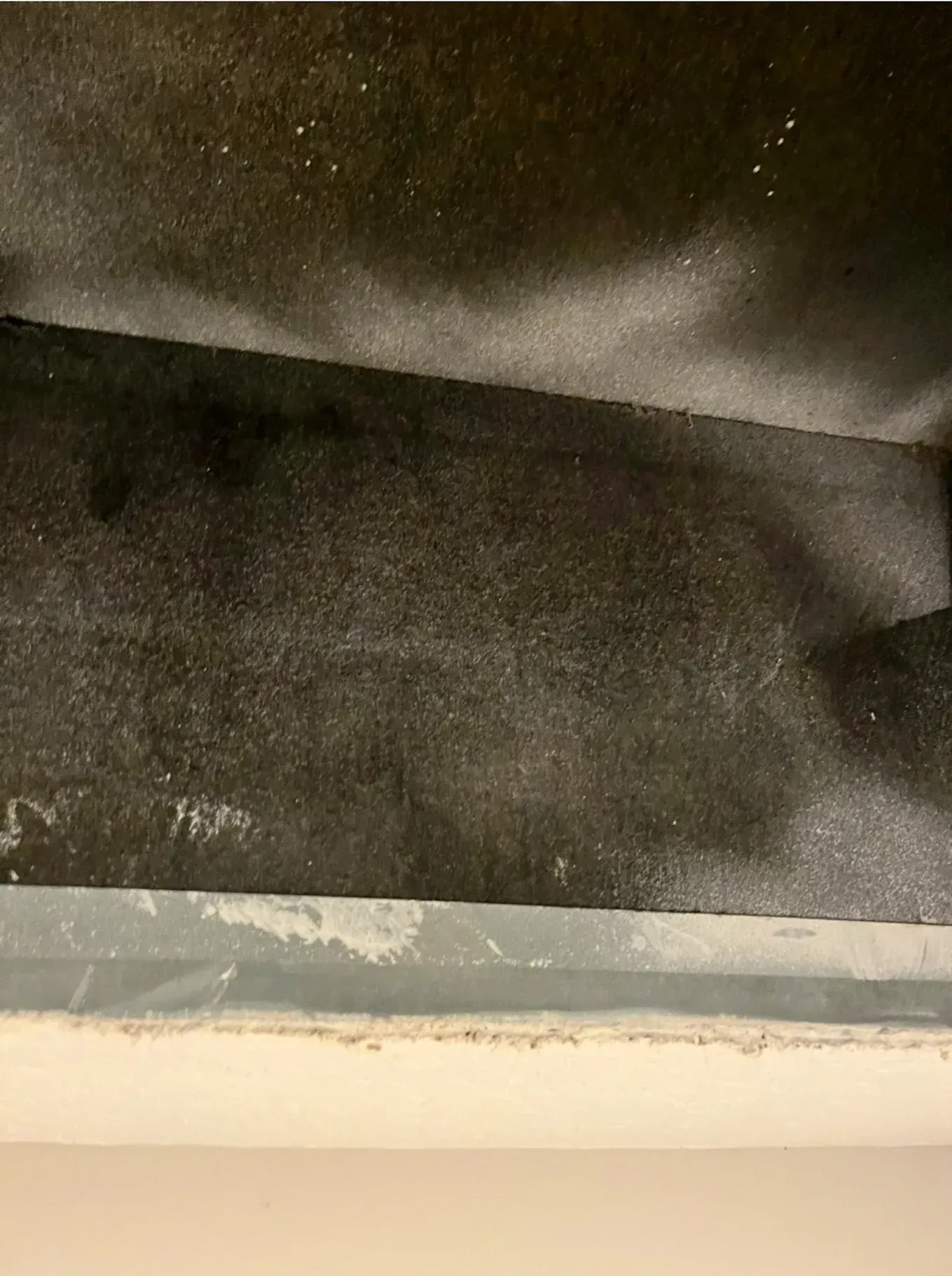 A black and white photo of a ceiling with a white trim.