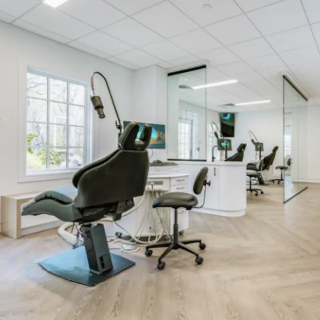 A dental office with a dental chair in the middle