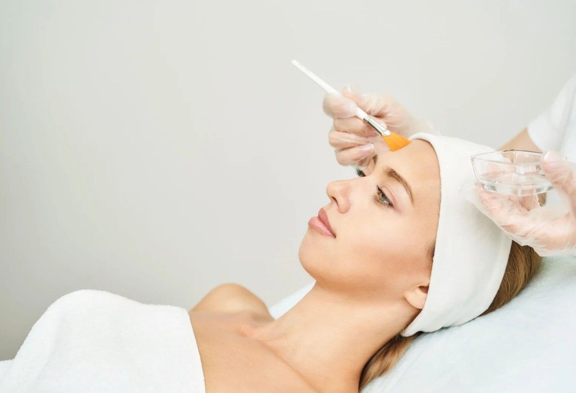 The Skin Studio applying lactic acid serum.