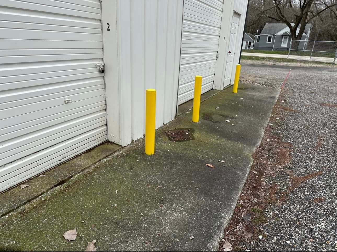 Storage units with yellow bollards.