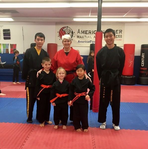 A group of people posing for a picture in front of a century sign