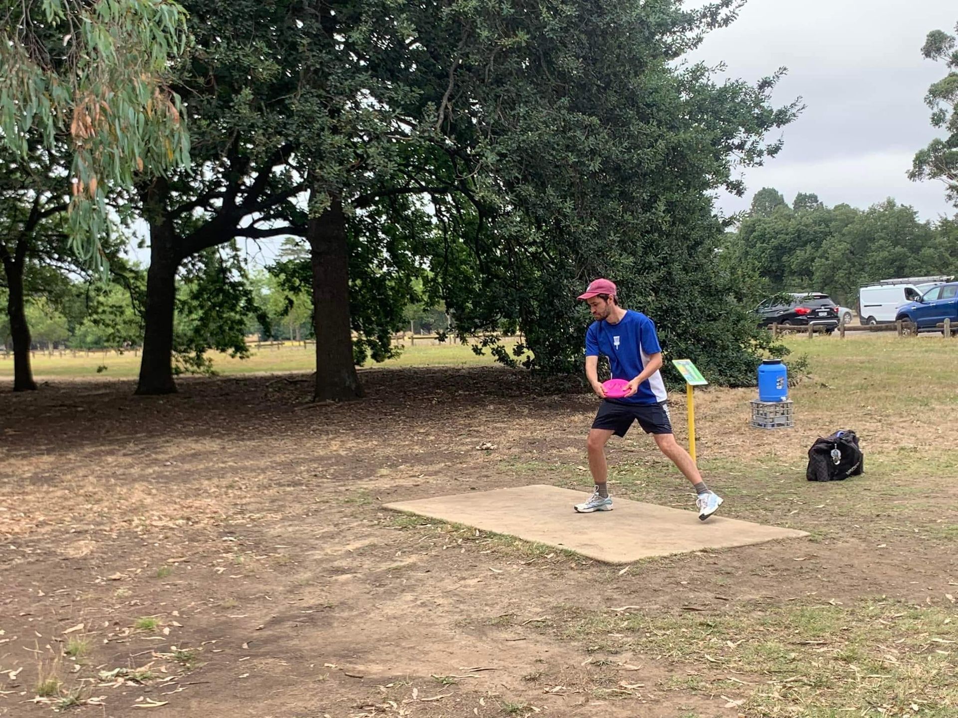 a man is throwing a frisbee in a park .