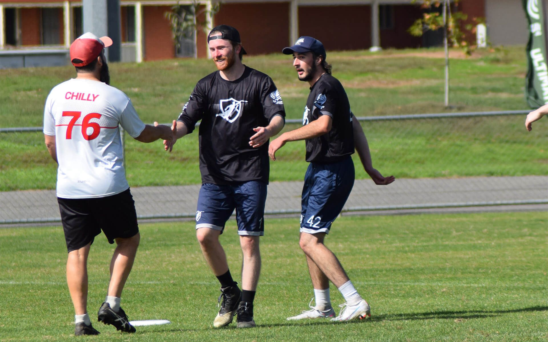 a group of men are playing a game of frisbee on a field .