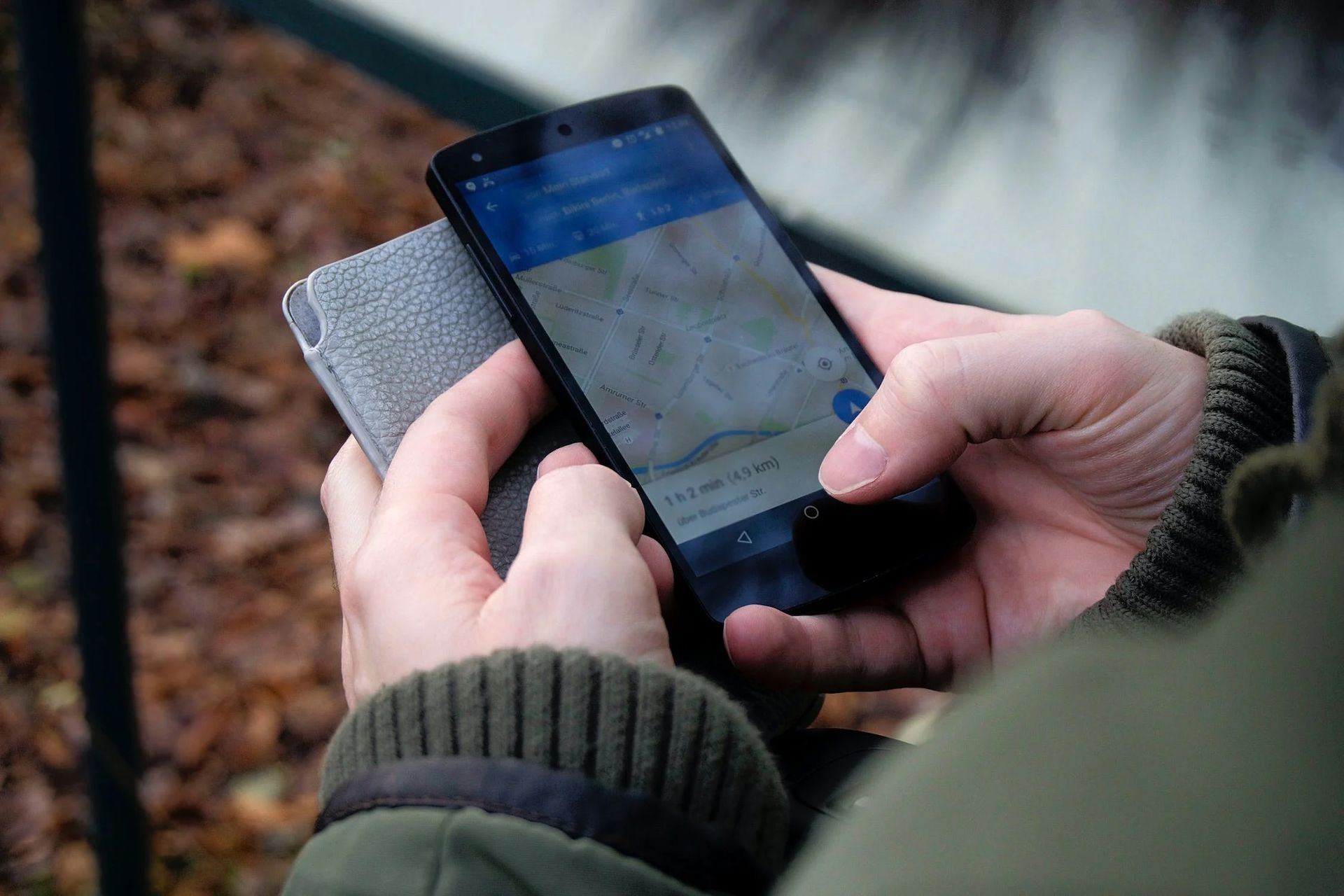 A person using Google Maps on a smartphone outdoors.